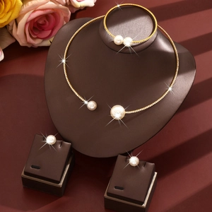 Elegant gold pearl jewelry set with necklace bracelet and earrings on luxury display