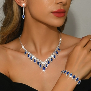 Elegant silver bridal jewelry set with blue teardrop pendants and sparkling crystals