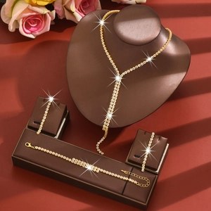 Elegant gold-tone jewelry set with crystal fringe necklace, bracelet and earrings