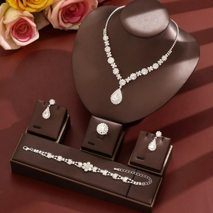 Elegant bridal jewelry set with silver teardrop necklace, earrings, ring, and bracelet