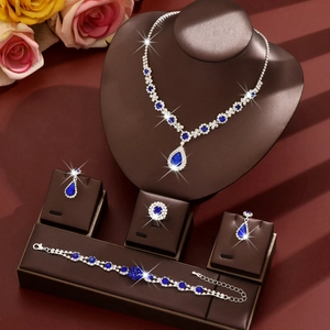 Elegant bridal jewelry set with pear-shaped blue sapphire gems and silver plating