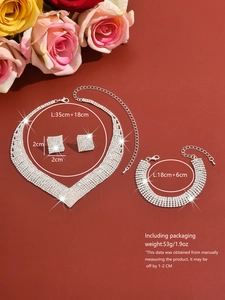 Detailed view of silver bridal jewelry set with sparkling rhinestones on red background