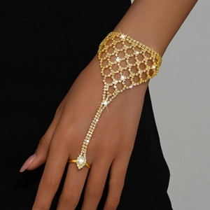 Elegant gold slave bracelet with sparkling zircons and a matching ring for formal occasions