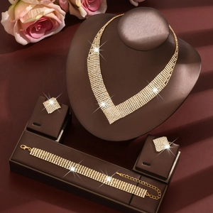Elegant gold bridal jewelry set with sparkling V-shaped diamond necklace and earring studs