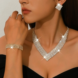 Elegant gold bridal jewelry set with V-shaped diamond necklace, bracelet and earrings