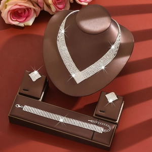 Elegant V-shaped bridal jewelry set with sparkling rhinestones on jewelry stand