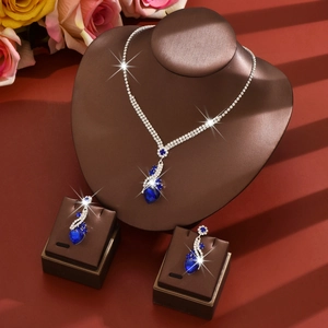 Elegant silver jewelry set with dark blue heart pendant necklace and matching drop earrings