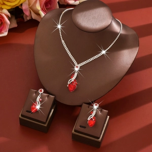 Elegant silver bridal jewelry set with red heart crystals including necklace and earrings