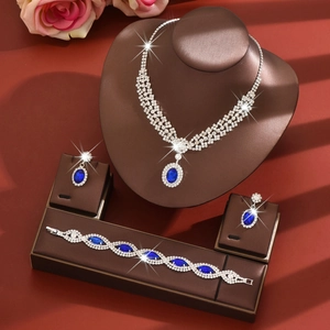 Silver jewelry set with deep blue oval stones and crystal halo including necklace and earrings