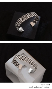 Macro detail of vintage braided silver metal cuff bracelet with intricate twisted texture