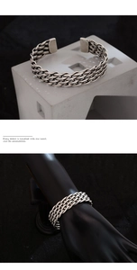 Detailed macro view of retro braided silver cuff bracelet with oxidized vintage texture