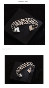 Detailed macro view of retro woven metal cuff bracelet with oxidized silver finish
