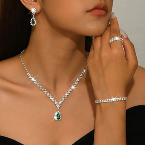 Classic silver jewelry set with green pear-cut zircon necklace, earrings, and bracelet