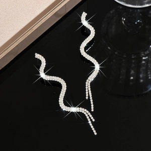 Elegant long wavy silver serpent earrings with sparkling rhinestones for evening wear
