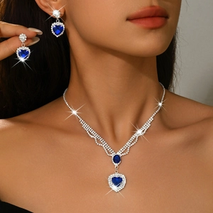 Elegant silver heart necklace and earrings set with deep blue crystals and small diamonds