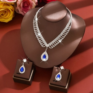Elegant silver necklace and drop earring set with blue crystals and sparkling stones