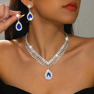 Elegant silver jewelry set with blue waterdrop pendants and sparkling white rhinestones
