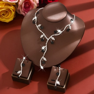 Floral bridal jewelry set with sparkling rhinestones and black flower accents on display