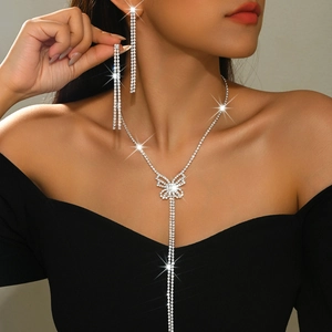 Elegant butterfly tassel necklace and earrings set with rhinestones on a female model