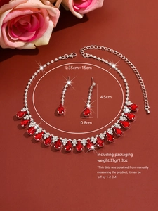 Detailed view of bridal jewelry set featuring red teardrop stones and dimensions