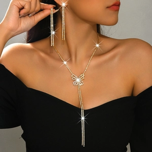 Close-up of sparkling butterfly jewelry set with long tassels and rhinestones on model