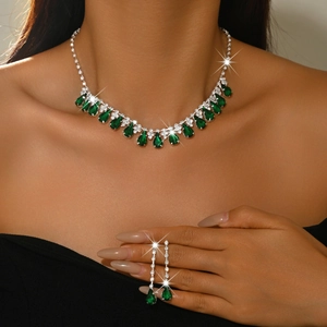 Luxurious bridal jewelry set with pear-cut green gemstone necklace and drop earrings