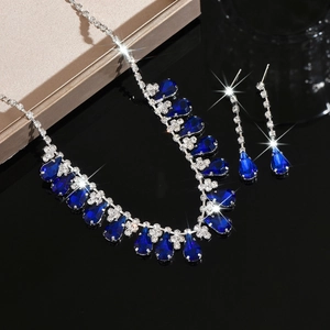 Detail of silver bridal jewelry set featuring dark blue teardrop pendants and tassels