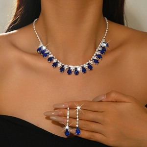 Detailed view of teardrop sapphire blue necklace and fringe earrings set for weddings