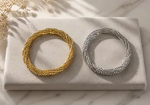 Detail of white enamel star waist chain belts in gold and silver packaging