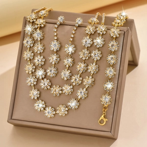 Close-up of golden sunflower jewelry set featuring sparkling diamonds on a velvet box
