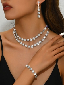 Detail of silver double-layer sunflower necklace and earrings set with sparkling stones