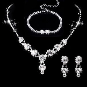 Silver bridal jewelry set featuring rhinestone V-shape necklace, earrings and bracelet
