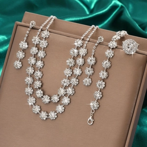 Detailed jewelry set with sunflower crystal necklace and earrings on green silk fabric