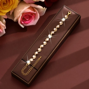 Detailed view of elegant pearl and rhinestone bracelet with lobster clasp in a jewelry box