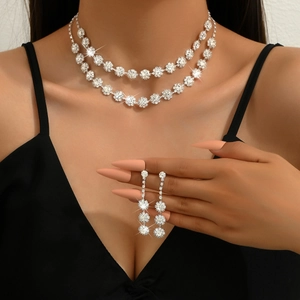 Close-up of double layer bridal jewelry set with sparkling floral crystals and earrings