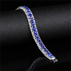 Three-row silver tennis bracelet featuring royal blue zircons and clear side stones
