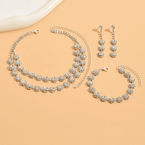 Close-up of sparkling silver sunflower necklace, bracelet, and earring jewelry set
