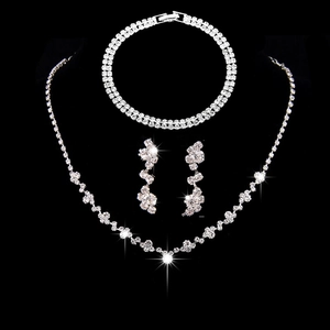 Detailed macro view of silver rhinestone jewelry set with necklace and drop earrings