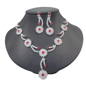 Elegant silver-toned necklace and earring set with red gemstones and clear crystals