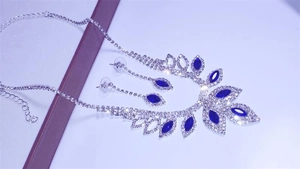 Detailed macro view of bridal jewelry set with navy blue stones and rhinestones