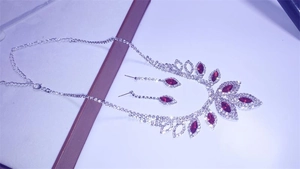 Detail of bridal jewelry set featuring red marquise rhinestones on a silver-tone necklace