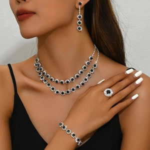 Detailed close-up of double-layer sunflower jewelry set with black and white rhinestones
