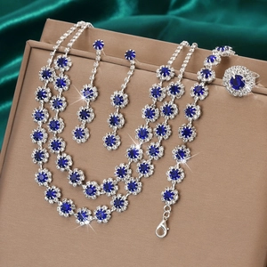 Detailed set of silver necklaces, earrings, and bracelet with blue sun-flower crystals