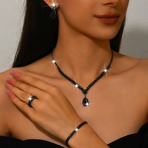 Close-up of black teardrop crystal jewelry set with necklace and earrings on a model