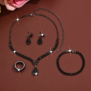 Elegant four-piece black rhinestone bridal jewelry set with necklace, earrings, and ring