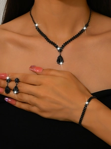Detailed view of elegant bridal jewelry set featuring black teardrop rhinestones