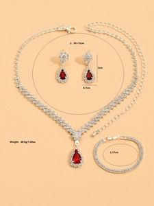 Detail of silver alloy jewelry set featuring red teardrop stones and white zircons