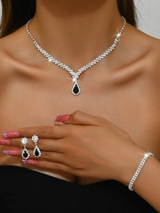 Detail of bridal jewelry set with black teardrop crystals and sparkling rhinestones