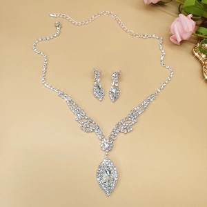 Detailed close-up of bridal jewelry set with silver marquise zircon necklace and earrings