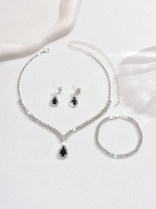 Detailed view of silver bridal jewelry set with black teardrop crystals and rhinestones
